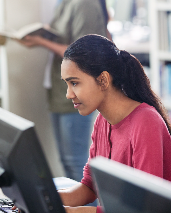 a girl looking at a computer screen